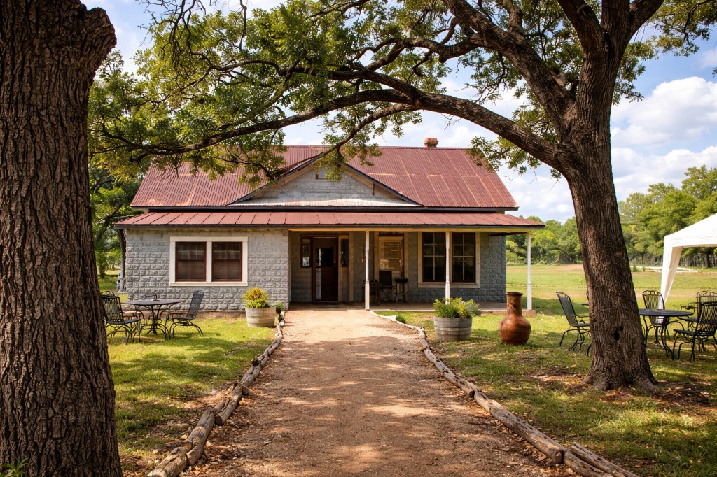 Rustic stone house and outdoor seating at a Hill Country venue