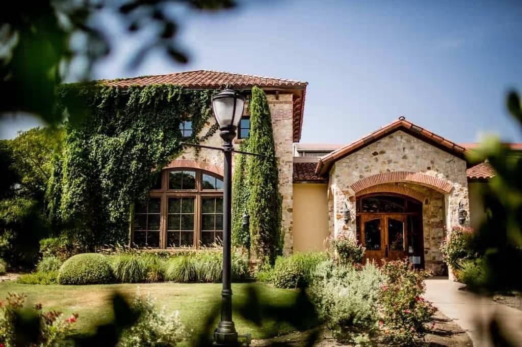 Stone and stucco winery building with terracotta roof