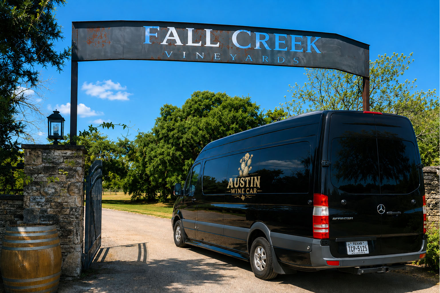 Black Mercedes Sprinter van with Austin Wine Car branding at the Fall Creek Vineyards gate