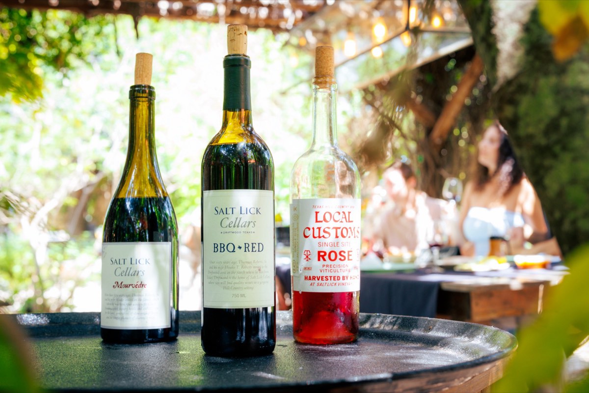 Salt Lick Cellars Mourvèdre, BBQ Red and Local Customs rosé on a table in Driftwood
